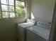 Laundry room with washer and dryer set next to window with view at 846 Burlwood St, Brandon, FL 33511