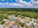 An aerial view shows an expansive neighborhood with homes nestled among trees, offering serene living at 8979 Hernando Way, Weeki Wachee, FL 34613