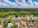 An aerial view shows an expansive neighborhood with homes nestled among trees, offering serene living at 8979 Hernando Way, Weeki Wachee, FL 34613