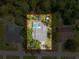 Aerial view of a home with a pool and surrounded by lush greenery, providing privacy and a serene setting at 8979 Hernando Way, Weeki Wachee, FL 34613