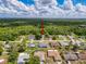 Aerial view showcasing a single-Gathering home nestled in a lush green neighborhood on a sunny day at 8979 Hernando Way, Weeki Wachee, FL 34613