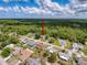 An aerial view shows a quaint neighborhood, with the home indicated by a red arrow at 8979 Hernando Way, Weeki Wachee, FL 34613