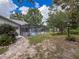 Landscaped backyard featuring pool area, and stone pathway to the home at 8979 Hernando Way, Weeki Wachee, FL 34613