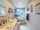 Bathroom featuring tiled floors, a vanity with marble countertop, and nautical themed decor at 8979 Hernando Way, Weeki Wachee, FL 34613