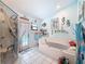 Bathroom featuring a tub, tile floors, glass shower, and access to outdoor pool area at 8979 Hernando Way, Weeki Wachee, FL 34613