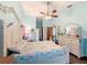 Relaxing bedroom featuring wood floors, a ceiling fan, and decorations at 8979 Hernando Way, Weeki Wachee, FL 34613