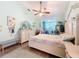 Bright and airy bedroom with charming decor, a ceiling fan, and a tranquil bay window nook at 8979 Hernando Way, Weeki Wachee, FL 34613