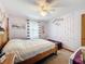 Inviting bedroom with beach themed decor and a comfortable bed with a white comforter at 8979 Hernando Way, Weeki Wachee, FL 34613