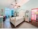 Light bedroom featuring wood floors, a ceiling fan, a sitting area, and relaxing decorations at 8979 Hernando Way, Weeki Wachee, FL 34613