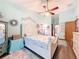 Tranquil bedroom featuring a ceiling fan, a decorative rug, and wood floors at 8979 Hernando Way, Weeki Wachee, FL 34613