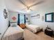 Bright bedroom with two twin beds, ceiling fan, carpeted floors, and beach themed decor at 8979 Hernando Way, Weeki Wachee, FL 34613