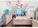 Comfortable bedroom featuring a ceiling fan, wood floors, and relaxing sitting area at 8979 Hernando Way, Weeki Wachee, FL 34613