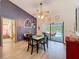 Open dining room with sliding glass doors leading to a covered patio and pool area at 8979 Hernando Way, Weeki Wachee, FL 34613