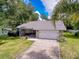 Charming single-story home with stone accents, a well-manicured lawn, and an attached two-car garage at 8979 Hernando Way, Weeki Wachee, FL 34613