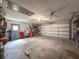 The spacious garage features a ceiling fan and ample room for storage at 8979 Hernando Way, Weeki Wachee, FL 34613