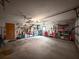 A spacious garage with plenty of storage options, features fans, and access door at 8979 Hernando Way, Weeki Wachee, FL 34613