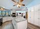 Bright kitchen featuring granite countertops, an island, stainless steel appliances, and ample storage space at 8979 Hernando Way, Weeki Wachee, FL 34613