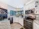 Modern kitchen featuring granite countertops, stainless steel appliances, and a bay window overlooking the backyard at 8979 Hernando Way, Weeki Wachee, FL 34613