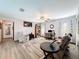 Cozy living room with a ceiling fan, hardwood floors, a decorative rug, and plenty of natural light at 8979 Hernando Way, Weeki Wachee, FL 34613