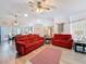 Spacious living area with tile floors, comfortable seating, and access to outdoor dining at 8979 Hernando Way, Weeki Wachee, FL 34613