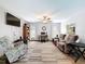 Spacious living room featuring hardwood floors, a ceiling fan, comfortable seating, and a flat screen TV at 8979 Hernando Way, Weeki Wachee, FL 34613