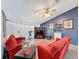 Cozy living room with vaulted ceiling, stylish ceiling fan, and comfortable red seating at 8979 Hernando Way, Weeki Wachee, FL 34613