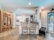 Open-concept living space with breakfast bar that overlooks the kitchen and entryway leading to a sunroom at 8979 Hernando Way, Weeki Wachee, FL 34613