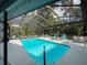 Relax by the screened pool, surrounded by trees and featuring chaise lounge seating at 8979 Hernando Way, Weeki Wachee, FL 34613