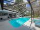 The sparkling pool surrounded by trees and lounge chairs, is perfect for summer fun at 8979 Hernando Way, Weeki Wachee, FL 34613