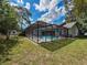 Enclosed backyard pool with plenty of seating space for entertaining and relaxing in this beautiful backyard oasis at 8979 Hernando Way, Weeki Wachee, FL 34613
