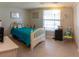 Bright bedroom features a white bed frame, large window, and beach-themed décor, creating a relaxing atmosphere at 9134 Crabtree Ln, Port Richey, FL 34668