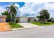 Charming single-story home featuring a one-car garage, mature landscaping, and a well-manicured lawn at 9134 Crabtree Ln, Port Richey, FL 34668