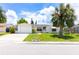 Charming single-story home featuring a one-car garage, mature landscaping, and a well-manicured lawn at 9134 Crabtree Ln, Port Richey, FL 34668