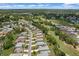 An aerial view captures a residential community next to a golf course and several ponds, with homes closely nestled together at 9149 Penelope Dr, Weeki Wachee, FL 34613