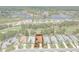 An aerial shot displays a home with a private backyard in a well-kept community with a golf course and a lake nearby at 9149 Penelope Dr, Weeki Wachee, FL 34613