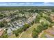 An aerial view captures a residential community next to a golf course and several ponds, with homes closely nestled together at 9149 Penelope Dr, Weeki Wachee, FL 34613
