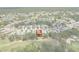 An aerial view highlights a lovely home, surrounded by the golf course and the beautiful community beyond at 9149 Penelope Dr, Weeki Wachee, FL 34613