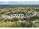 An aerial perspective captures a neighborhood bordering a golf course, with manicured lawns and tree-lined streets at 9149 Penelope Dr, Weeki Wachee, FL 34613