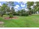 Manicured backyard landscaping with healthy green grass and hedges at 9149 Penelope Dr, Weeki Wachee, FL 34613