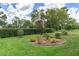 Backyard with well-maintained lawn, small decorative landscaping beds and mature perimeter hedging at 9149 Penelope Dr, Weeki Wachee, FL 34613