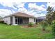 Exterior view of house with screened patio and manicured landscaping at 9149 Penelope Dr, Weeki Wachee, FL 34613
