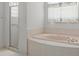 Bathroom featuring a corner tub and a separate glass-enclosed shower at 9149 Penelope Dr, Weeki Wachee, FL 34613