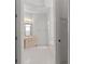Bathroom featuring double doors, vanity with lights, and tub at 9149 Penelope Dr, Weeki Wachee, FL 34613