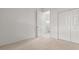 Carpeted bedroom with an en-suite bathroom and large closets at 9149 Penelope Dr, Weeki Wachee, FL 34613
