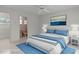 Bright bedroom featuring a comfortable bed with blue accents and an ensuite bathroom at 9149 Penelope Dr, Weeki Wachee, FL 34613