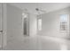Spacious bedroom featuring tile floors, a ceiling fan, and natural light at 9149 Penelope Dr, Weeki Wachee, FL 34613