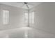 Bright bedroom with tile flooring, neutral walls, and multiple windows at 9149 Penelope Dr, Weeki Wachee, FL 34613