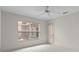 A light filled room with white floors and a large window with a view to the outside at 9149 Penelope Dr, Weeki Wachee, FL 34613