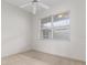 Sun-lit bedroom with a ceiling fan and large window overlooking the neighborhood at 9149 Penelope Dr, Weeki Wachee, FL 34613