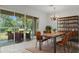 Dining room with tile floors, chandelier, and views to the backyard through glass sliding doors at 9149 Penelope Dr, Weeki Wachee, FL 34613